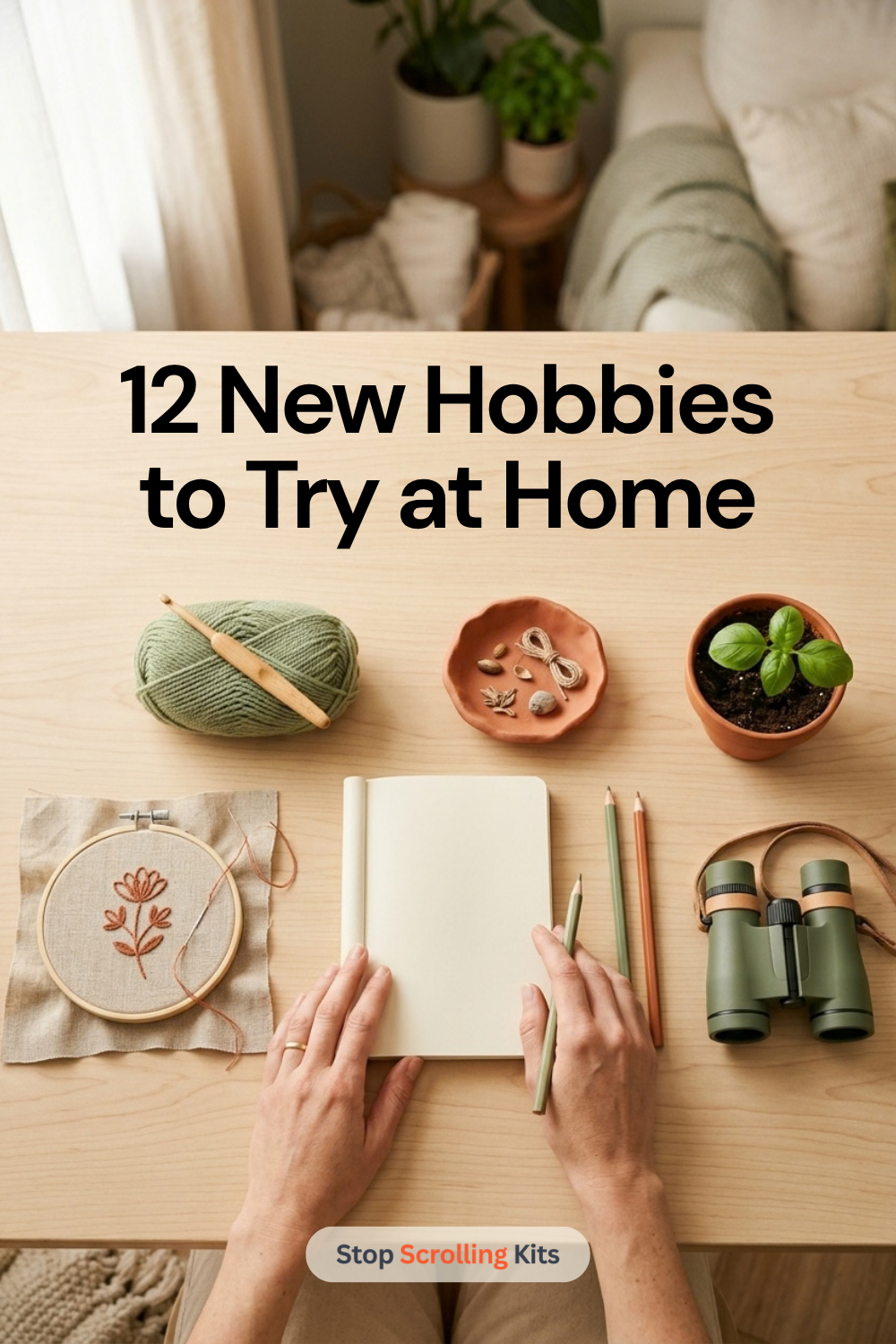 hands on a table with a journal pen embroidery hoop binoculars air dry clay bowl herb plant crochet hook and yarn