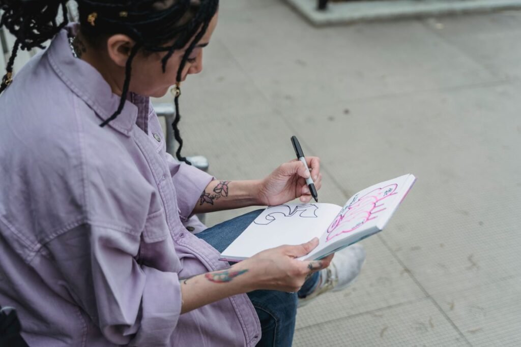 woman drawing in small notepad